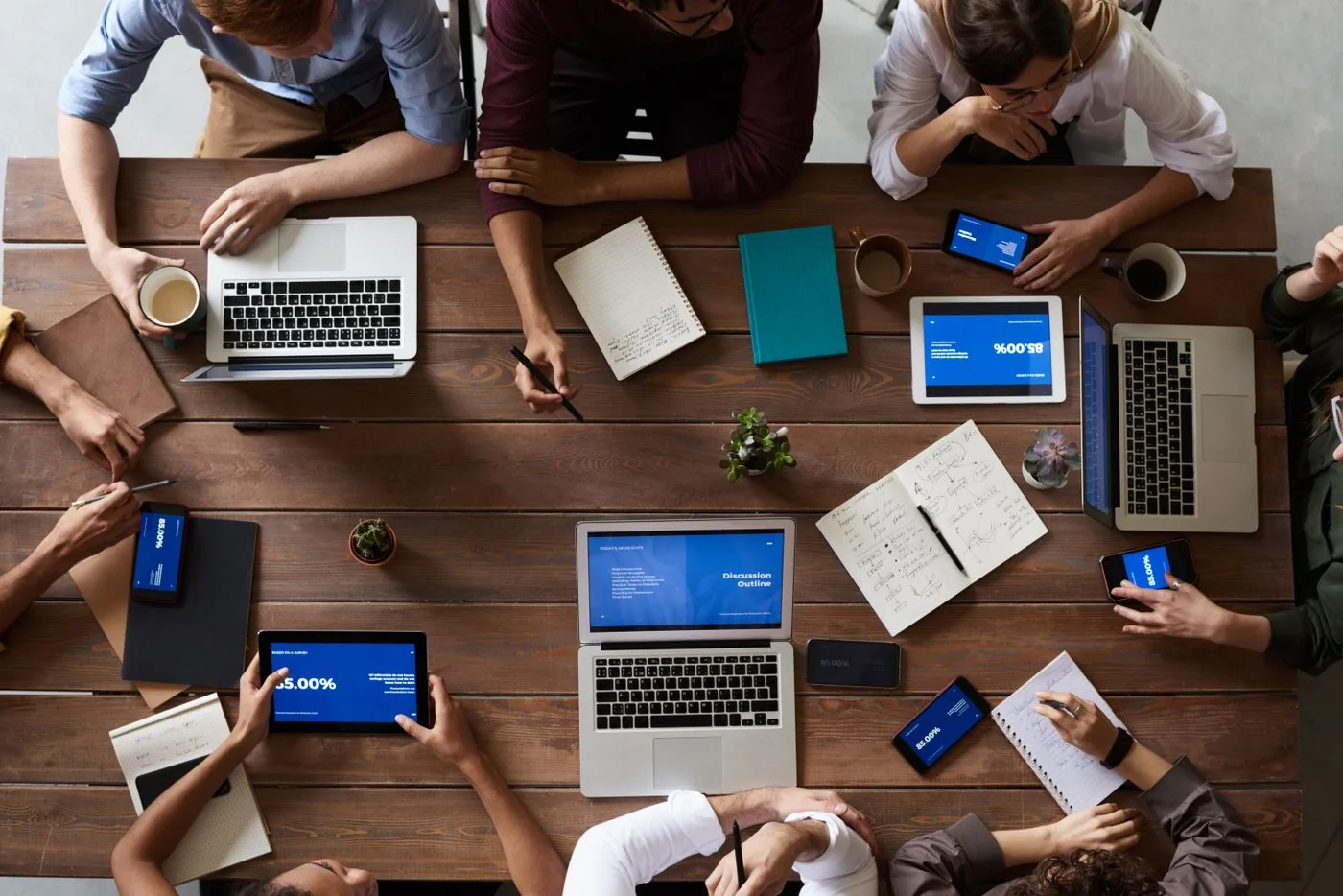 Keyword research basics — overhead view of collaborative planning with laptops and notebooks