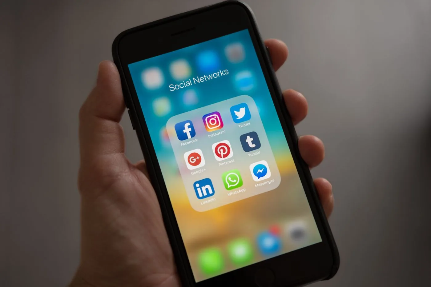 Instagram Ads in Mysore — hand holding a smartphone with social media apps
