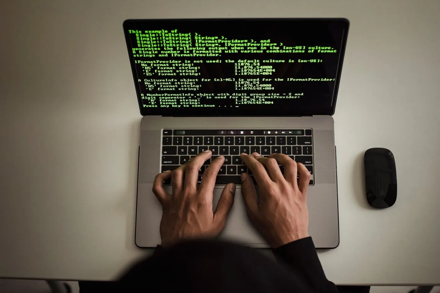 AI Marketing Course — hands working on a laptop displaying software code