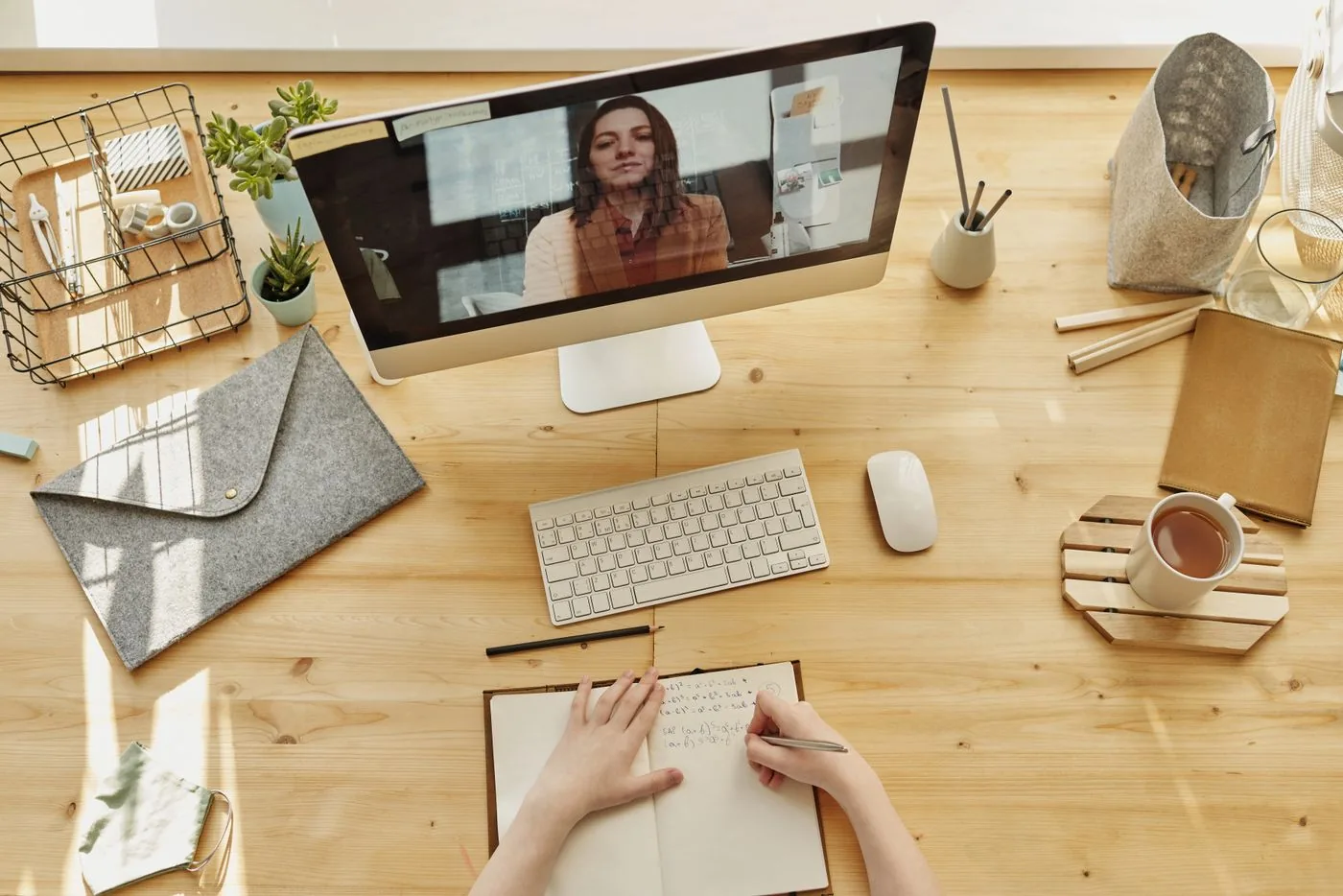 Online versus classroom learning — learner taking notes during a video lesson
